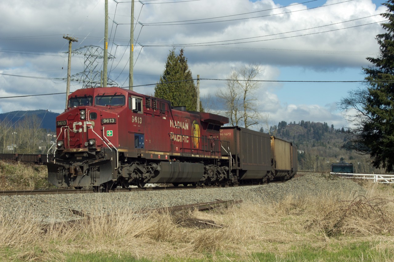 Trailing unit of empty C.P.R. coal train crossing the Fraser River at Abbotsford and Mission, B.C.