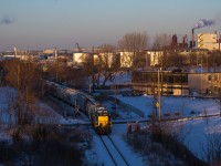 Another cold winter's day is coming to a close as RLK 3873 shoves a healthy string of grain cars towards Bunge Inc., along the old N&NW Spur. Some of Hamilton's many waterfront industries and the Skyway bridge, can be seen in the background. 