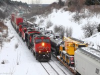 CN 121 passes CN X301 at Hilda, having a decent 4 unit lashup. As seen in the photo, perfect timing brought a yellow crane on X301 going the other direction.