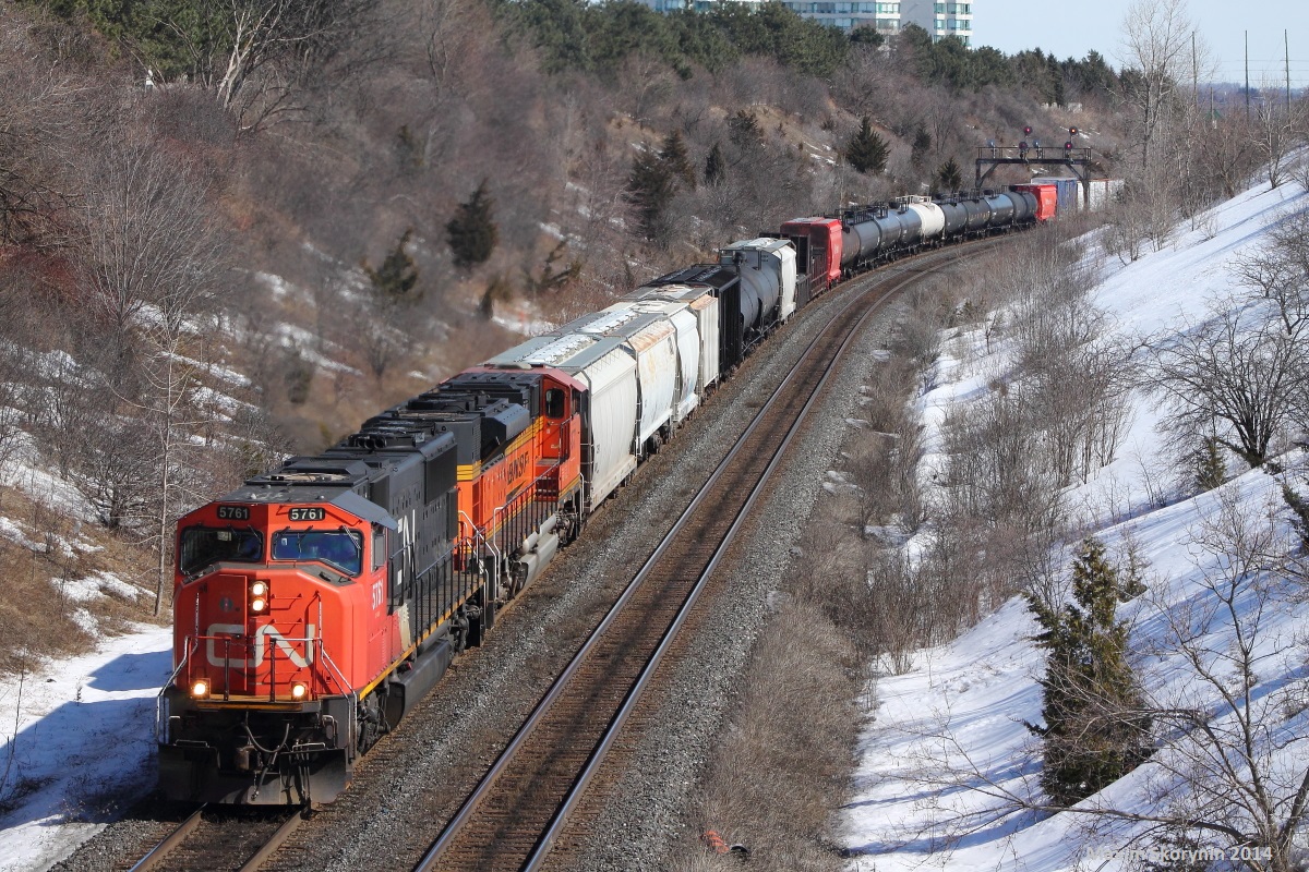 As the sunny +13 degrees March weather comes, I am able to head down to Hilda for a few hours to watch some trains. In a short time, we get this train lined and we see it come around the bend as we take our photos. For those who dont notice, this train has some American friends on board. Trailing is a BNSF SD70M, coming from the United States on lease to Canadian National. This is somewhat rare and pleasant to see, but with the recent FPON rush here in southern Ontario on both CN & CP, this is a fairly common sight.