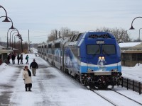 Montreal bound AMT train stops at Dorval station picking up commuters to deliver them to downtown, with a decent looking engine up front.