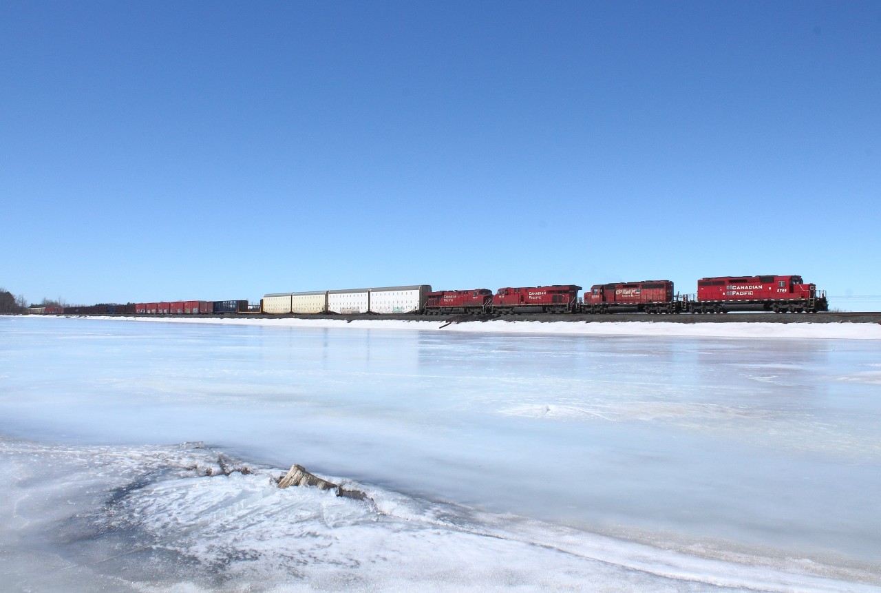 Over the frozen reservoir, 2 SD40-2's and 2 GE's are on point of a eastbound. After a while of editing, i finally made this photo properly exposed. I hope.
