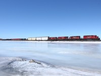 Over the frozen reservoir, 2 SD40-2's and 2 GE's are on point of a eastbound. After a while of editing, i finally made this photo properly exposed. I hope.