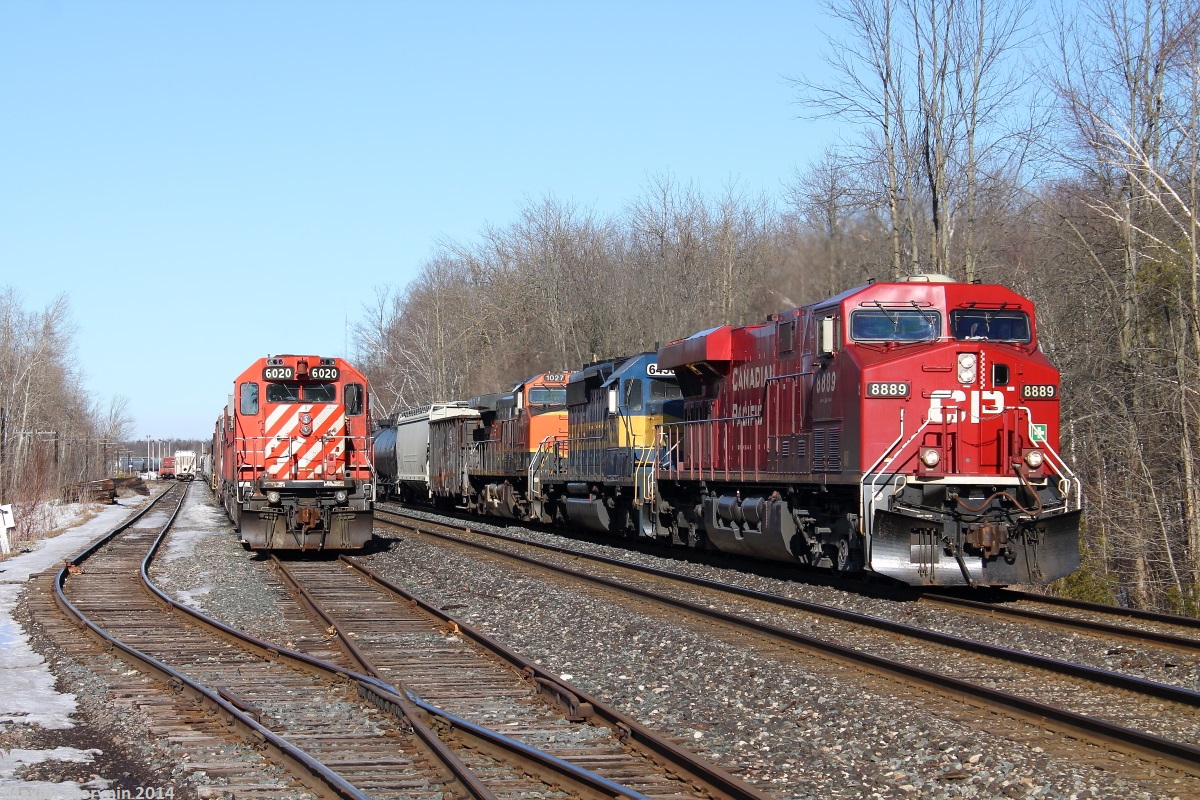 One digit less, it would have been the crazy eights unit! CP 255 with some foreign power from America, including trailing Iowa Chicago & Eastern Railway and Burlington Northern Santa Fe Railway, passes stopped CP CWR (Rail Train) on the left stopped at Guelph junction.