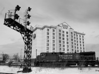 [Ed: Artistic merit] CP freight passing Dorval with a railfans dream hotel in the back  