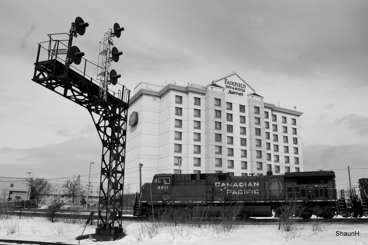 CP freight passing Dorval with a railfans dream hotel in the back