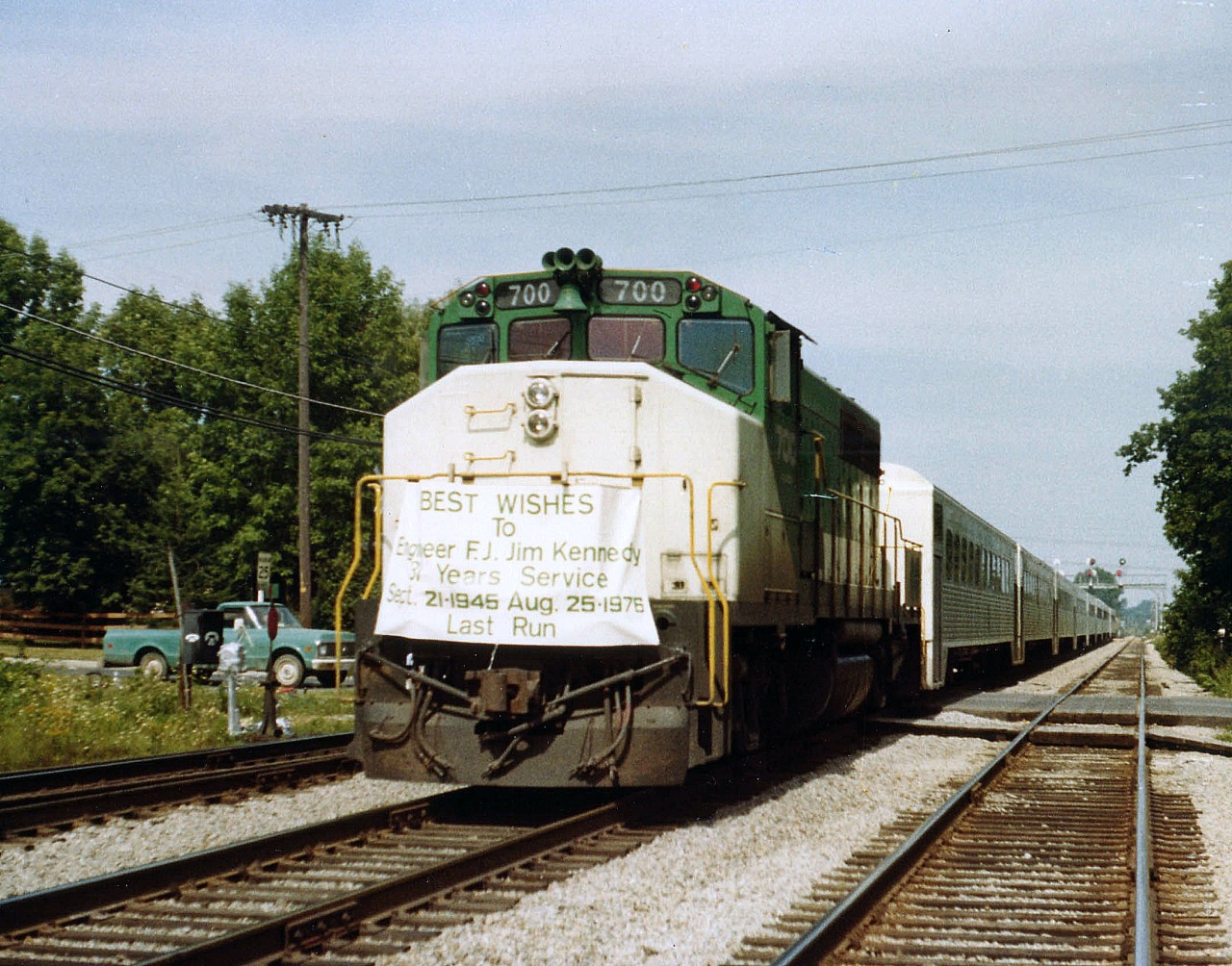 Photos such as this with a banner gracing the locomotive have always been extra special for me. I guess it is because of the human element involved.  For this is the ONLY run to carry such banner, a one-of-a-kind memorial trip for the engineer and a once only time for the photographer. Thirty-one years service!!  I wonder where he ran before he latched onto GO?? No doubt the reward for all those years was to finish off his career being able to go home every evening. This GMD GP40-2(W)became CN 9668 in 1991, and according to "sdfourtys" caption was dealt off in 2002. His delightful image of GO power sitting at Mimico, with #700 visible, made me recall this particular shot of many years ago........