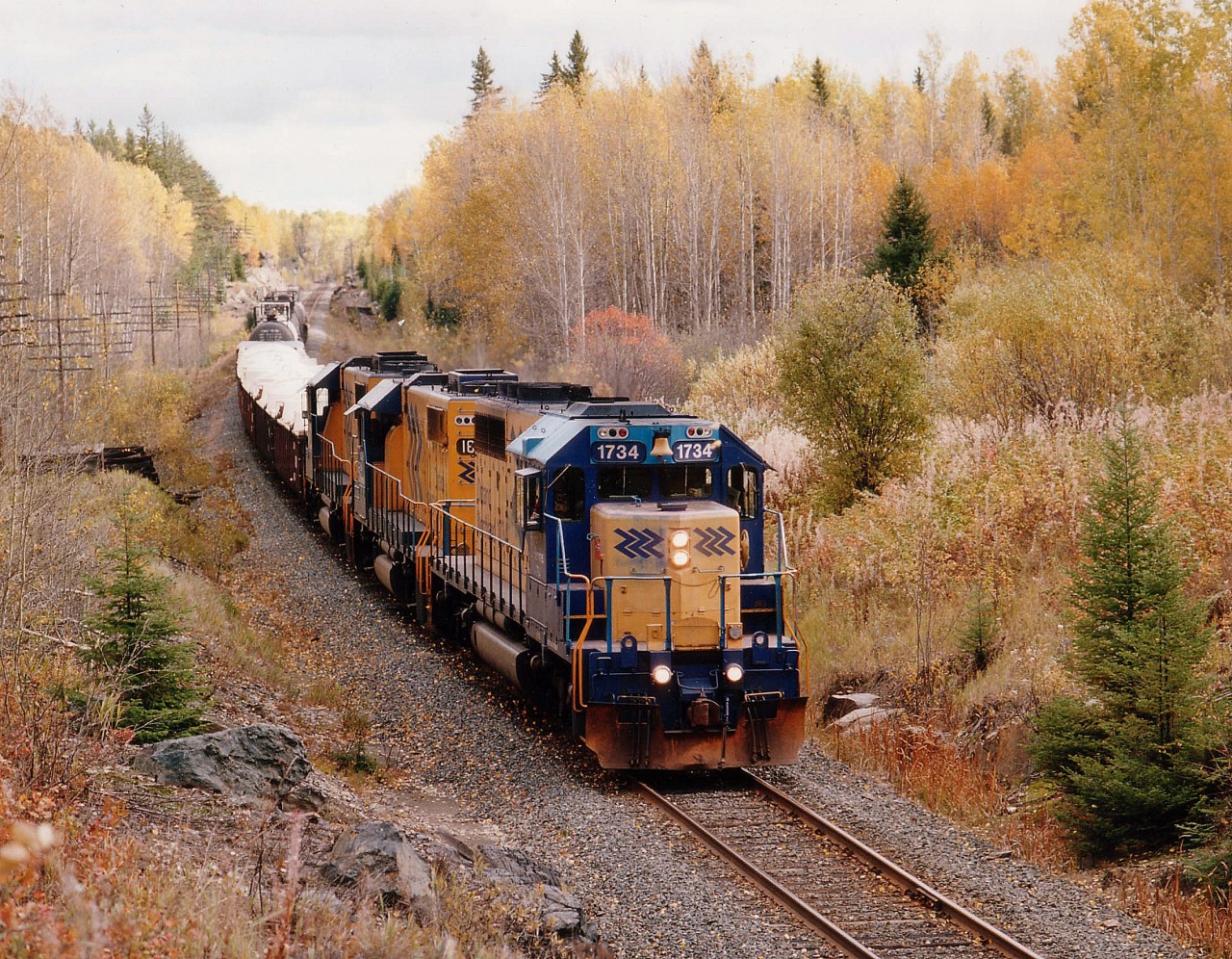 Its a nice bright late fall day as a northbound, having just left Englehart, with ONR 1734, 1806 and 1808 is about to duck under Hwy 112 on its way to Swastika and the junction taking this short train thru Kirkland Lake onward to Rouyn-Noranda. All three units are still in active service as of 2013.