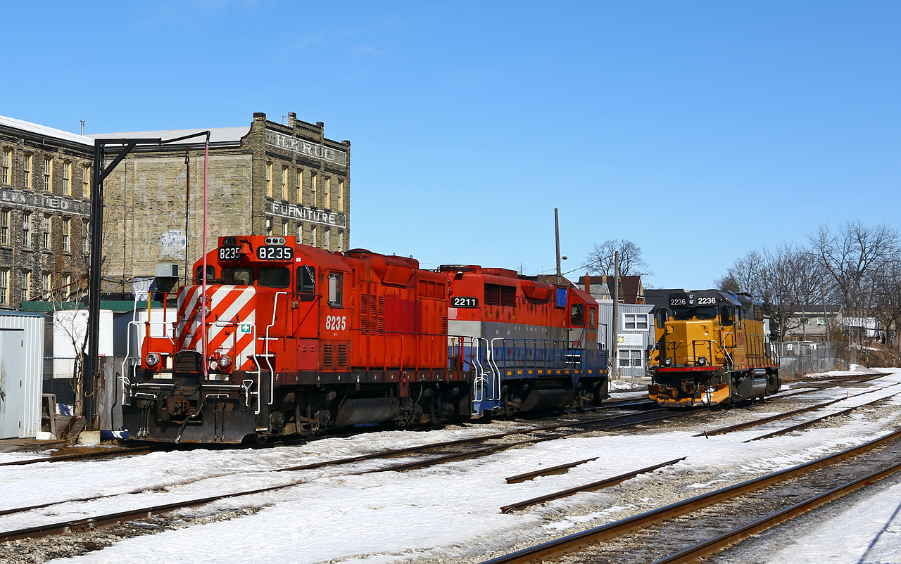 Former CP comrades OSR 8235, and a bit less obvious, RLK 2211 have the day off along with LLPX 2236 as they idle on the shop tracks out front of the VIA/GO station in Kitchener. Note that the main in the foreground has been redirected through a shoo-fly around the Duke street underpass construction project, and the passing track has been severed.