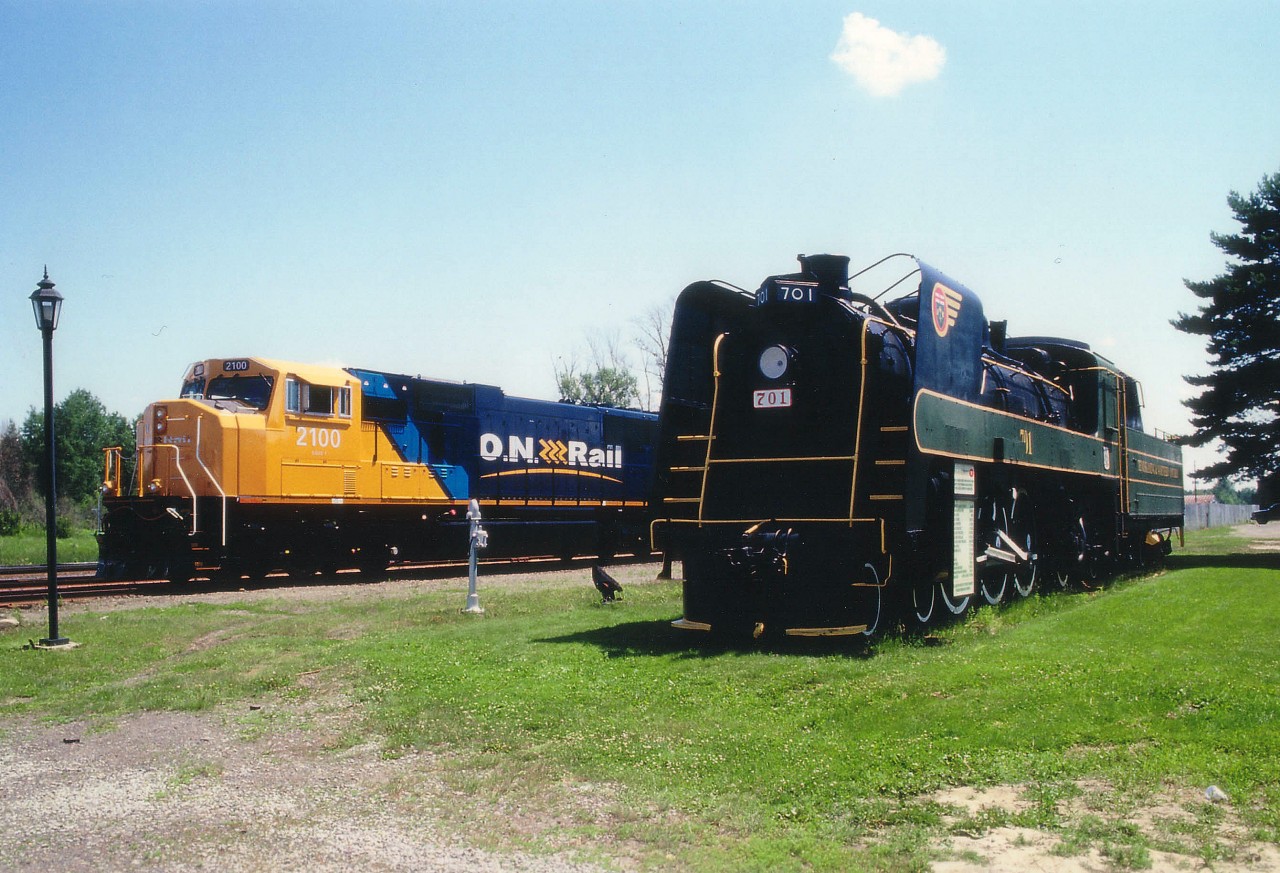 The Old and the New. On the longest day of the year with the sun up high and hot, we see the brand-new $2.8M ONR SD75I #2100 on display for all at the Englehart station and head office. John Thib, I believe ONR General Manager at the time, ushered me aboard to have a look around. Nice, but for all that money one would think it would come with hotplate AND air-conditioning..NOT a choice of either. This new on the scene locomotive was parked next to the T&NO (Temiskaming & Northern Ontario) #701, maintained in pristine condition with pride as a tribute to the very last steam engine that ran on these rails, retiring to display after the June 25, 1957 farewell. The engine began life as #158 in 1921, then to #758 in 1935, and #701 in 1940. Oddly enough, in retirement it ended up outlasting the ONR 2100, which was wrecked April 12, 2011 and subsequently mothballed.