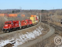 <b>Bayview Junction</b> was the place to be if you wanted to see pushers in action, especially on the CN in Steam and early Diesel days - a spur track at far right would have hosted the pusher engines (Search the site to see more Bayview Junction images with pushers). In modern times, CN yard engines at Aldershot double as pushers as needed. CP is now in the game - the Kinnear yard power seen here doubling as manned pushers, the geeps groaning as they shove 142 up the hill.