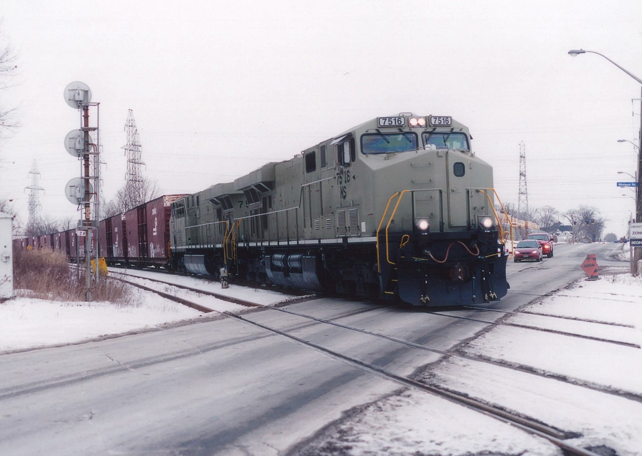 The power on this #328 is unusual, even for a train that was known by photographers to feature just about anything that rolled. This "Stealth" lashup sneaked through Niagara until getting caught by the lens rolling over Stanley Av in Niagara Falls on its way onto the CN Stamford Sub and Fort Erie to Buffalo. Only 20 of these ES40DC NS locos are noted in the CTG; built between 2004 and 2008, and as I remember many units built during this period were rushed into service before painting, as the NS was rather power short. Two in primer, in this case 7516 and 7517, out of the 7500-7519 series,  in Southern Ontario on a train was definitely rare. Likely unique.