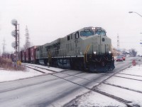 The power on this #328 is unusual, even for a train that was known by photographers to feature just about anything that rolled. This "Stealth" lashup sneaked through Niagara until getting caught by the lens rolling over Stanley Av in Niagara Falls on its way onto the CN Stamford Sub and Fort Erie to Buffalo. Only 20 of these ES40DC NS locos are noted in the CTG; built between 2004 and 2008, and as I remember many units built during this period were rushed into service before painting, as the NS was rather power short. Two in primer, in this case 7516 and 7517, out of the 7500-7519 series,  in Southern Ontario on a train was definitely rare. Likely unique.