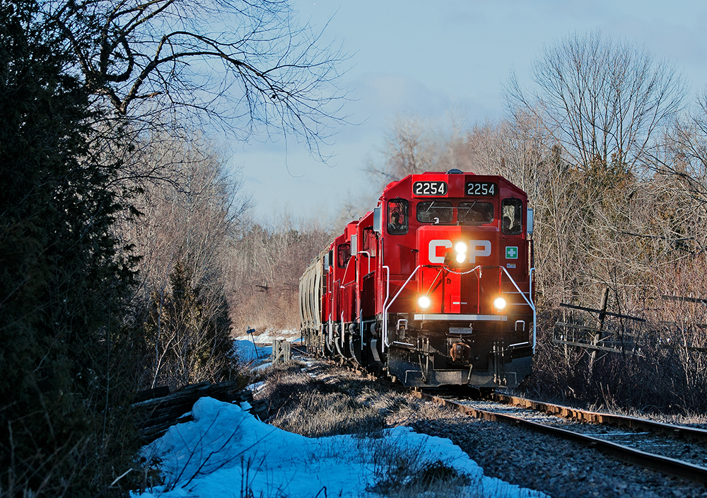 Built as the original mainline to Glen Tay from Toronto for the Ontario and Quebec Railway,  CP 2254 East trundles along on what's left of the Havelock Subdivision with 5 empty hoppers for the nepheline syenite mines in Nephton, Ontario. Although track speed between mile 178 and mile 94.3 is 30 MPH, a 10 MPH rule 43 blankets the section making this a slow trek back to Havelock for the crew.