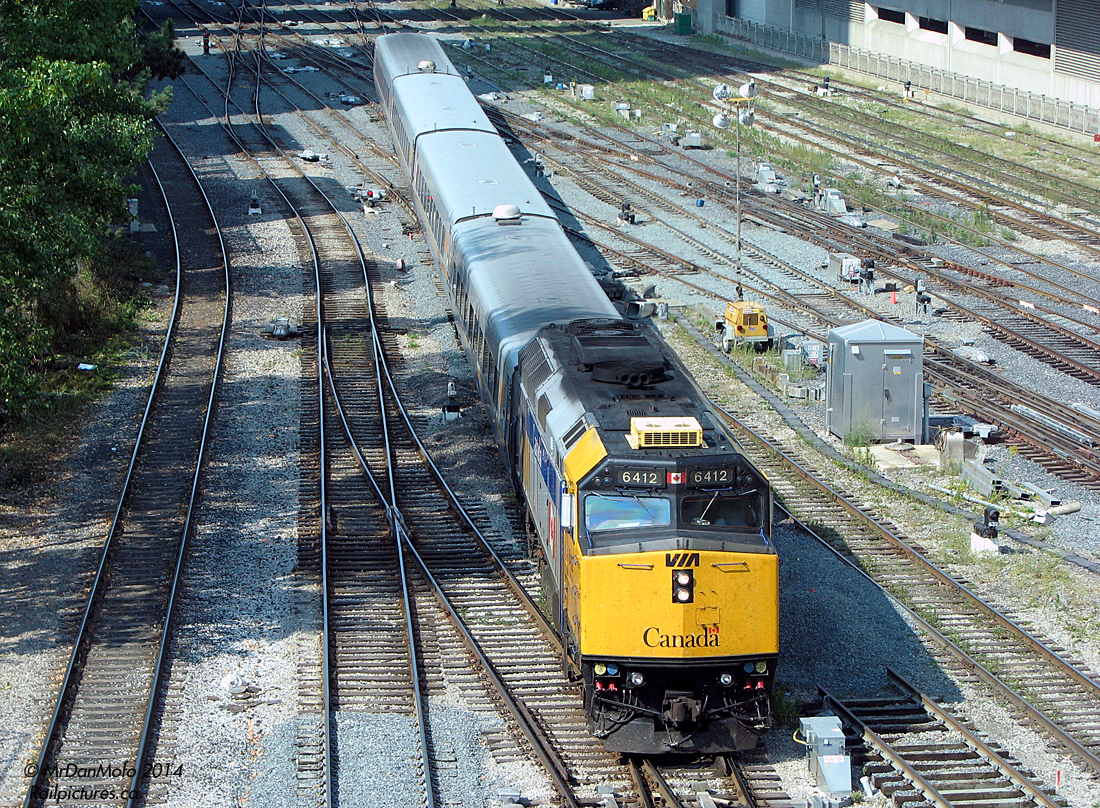 Negotiating the spaghetti mess of rails and slip switches past John Street interlocking tower, which is in charge of train movements into and out of the corridor, a 14-minute late VIA 84 from Sarnia arrives at the end of its run at Toronto's Union Station. Power today is F40PH-2 6412 plus the usual 4 LRC car consist.
