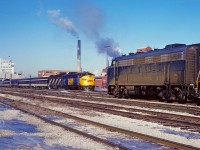 In this scene from 35 years ago, N&W 3725 with train ND29 arrives at Windsor and heads for CN's Boat Yard along the Detroit River. VIA 6539 with train 74 prepares to depart for Toronto.