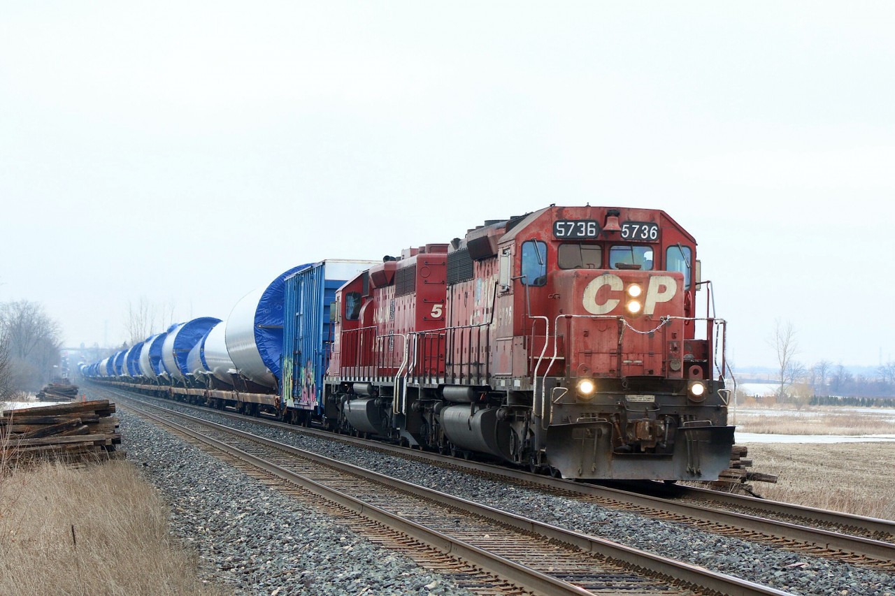 A wind turbine train rolls westbound through Hornby after mechanical issues delayed the train the previous day.