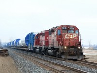 A wind turbine train rolls westbound through Hornby after mechanical issues delayed the train the previous day.