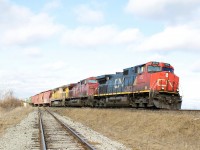 A colourful CN 399 with CP 9683 and CN 2014 on UP yellow trailing passes the glass lead at milton. 