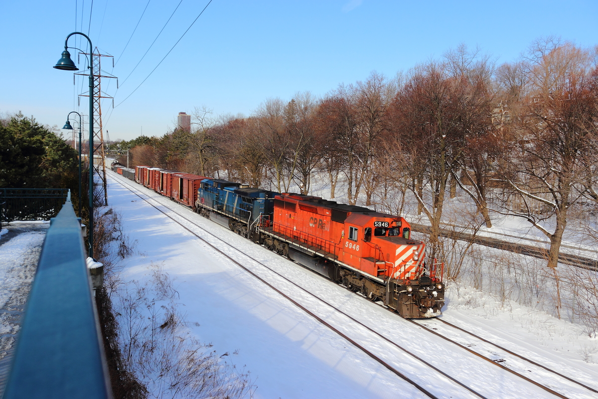 Just a few hours ago, I traveled to a location previously unvisited by myself, to see what I could catch in a few morning hours. Just as I arrived, I noticed one of the two signals was red over red unlike its default position, amber over red. I rushed to pull my camera out of my bag, and within a few minutes, this westbound train comes through with a cool consist of a CP SD40-2 and a CEFX locomotive. It's not often you see anything other than GE locomotives leading on CP anymore, so it's nice to have a little variety sometimes.