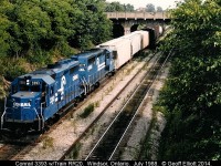 Conrail train RR20 is gliding downgrade into the Windsor/Detroit rail tunnel on a hot July day in 1988.  RR20 had delivered cars to the CP yard in Windsor earlier and was headed back to River Rouge yard..