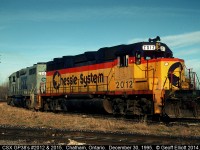 CSX GP38's 2012 and 2015, having delivered cars to the CP earlier, now rest on the the southeast connection to CP yard in Chatham, Ontario back on December 30, 1995.