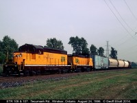 ETR 108 and 107 pull a long cut of cars into the CP/ETR Interchange track just south of Tecumseh road back in 1996.