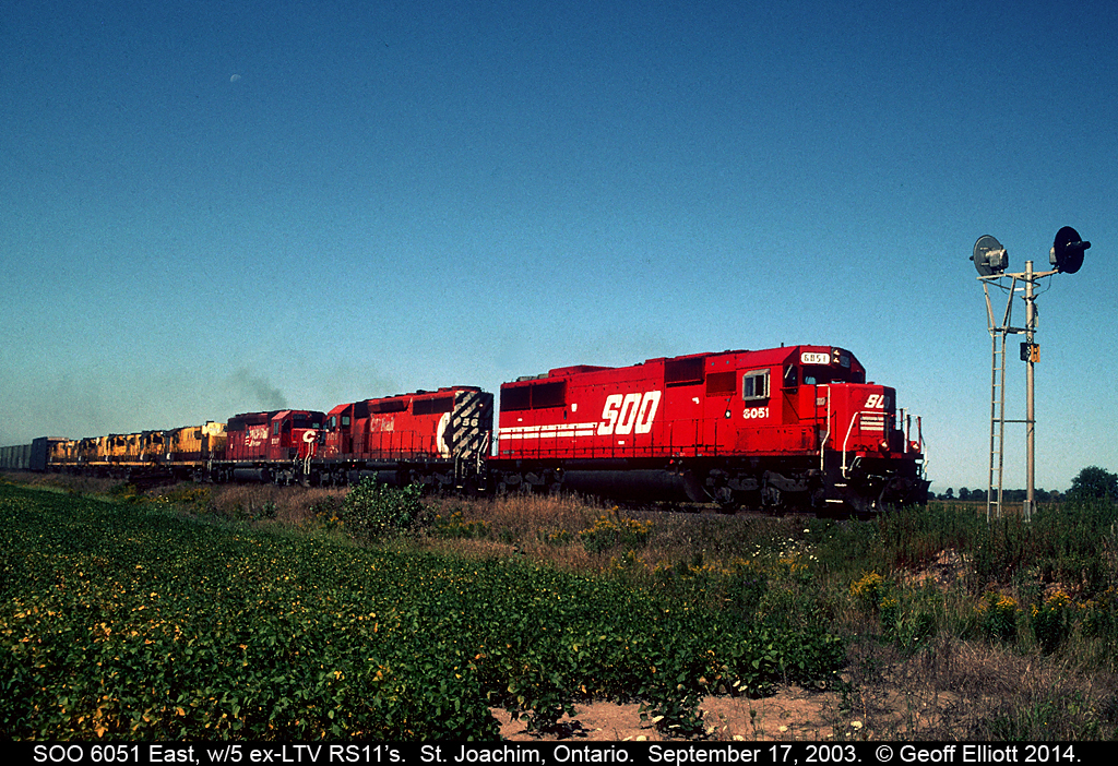 SOO 6051 leads 2 CP SD40-2's and 5 ex-LTV mining RS11's eastward as it is about to cross the Rochester Town Line, just east of St. Joachim, Ontario on September 17, 2003.  The ex-LTV units have been given another chance at life and are bound for the Morristown and Erie railroad.