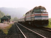 The Amtrak International Limited has stopped on signal at Dundas in order to pick up passenger(s) on its 0915 arrival time on a rather foggy September morn. On clear days, sun angle would make this photo almost impossible. Others out front of the station are awaiting the VIA Tempo #71, close behind.