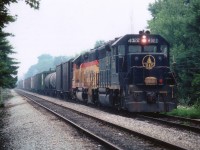 Back when the mainline that ran from the Niagara bridge down to Brookfield was double tracked thru the city of Niagara Falls, we see the late (steamy) day #321 with an old paint leading, B&O 4022, with the newer Chessie System yellow 4394 behind. The train is around Milepost 1 which paralleled Palmer Av in town. Hard to believe this image was taken in the city.