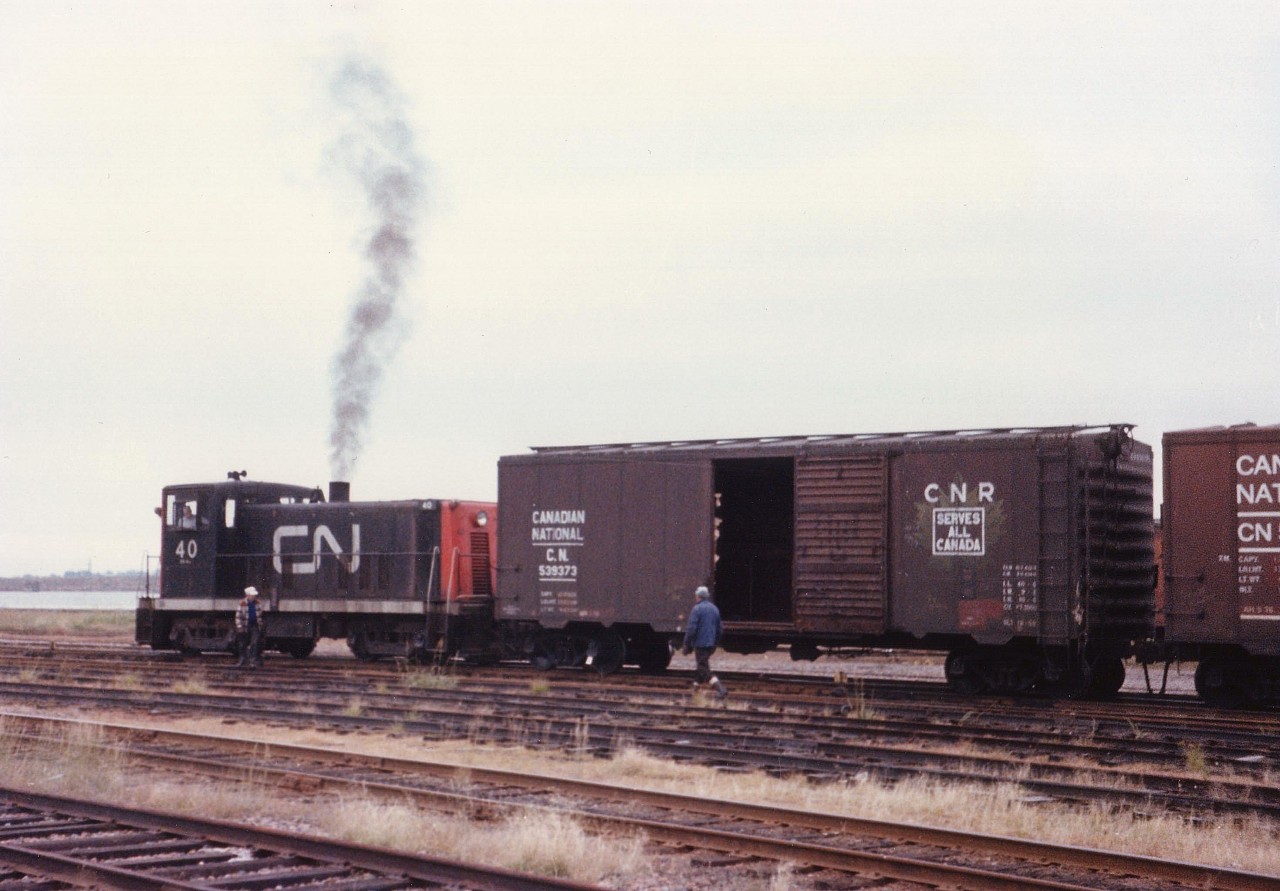 CN 40 switches the yard on a dull overcast September back in 1977 down near the Charlottetown waterfront. This unit and its other 70 ton partners were gone from the island by 1983. All rail activity, in fact, ceased on Prince Edward Island by 1989, and scenes like this are but a distant memory.