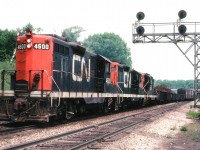 Nice trio of CN GP9s rolling thru Bayview, a train bound for Fort Erie on account all these units and many other Geeps were based at Fort Erie for a lot of their lifetime. A rather dull, quiet day as it was a Tuesday and most people at work, even those we cannot really see in this image .......after all, the "famous" Bayview Walkbridge was Under Construction; it can just barely be seen in the right background.  This structure is like so many others in 'train-land'. We use them for photographic locations but somehow we never seem to include the structures themselves in any of our shots. Power on train is CN 4600, 4589 and 4577.