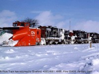 After a day of plowing in Ontario snowbelt country, a CN plow train rests back in front of the station at Stratford. CN plow 55408 has plenty of power behind it, pushed by a trio of frozen looking GP9's (4593, 4561 and 4568). A snow-covered van punctuates the rear of the train, although if the crew inside of it could see anything going on ahead of them is anyone's guess. <br><br> For another view of CN 55408 (that later went GEXR) plowing on the "Bruce branches": <b><a href="http://www.railpictures.ca/?attachment_id=13997">http://www.railpictures.ca/?attachment_id=13997</a></b>. <br> And a CP plow train: <b><a href=http://www.railpictures.ca/?attachment_id=14417>http://www.railpictures.ca/?attachment_id=14417</a></b>.
