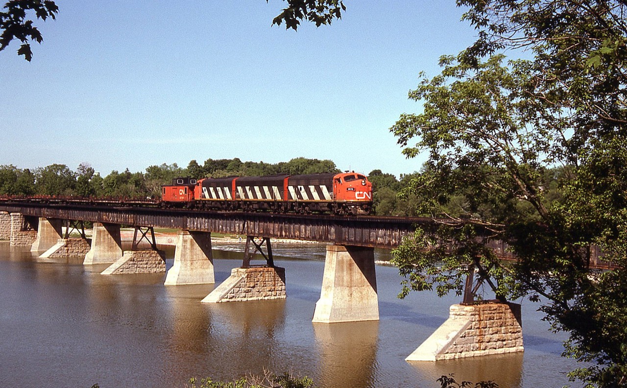 Rolling east over the Grand River bridge in Caledonia, CN 9173 leads her matching A-B-A set of zebra F7's eastbound on the Hagersville Sub on the Steel Train.

CN Steel Train on same day:
Crossing in Caledonia: http://www.railpictures.ca/?attachment_id=14684
Rymal outside of Hamilton: http://www.railpictures.ca/?attachment_id=14618
