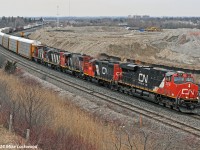 An interesting mix of older power tags along behind CN 2278 heading up 372's train. In order are CN 4018, 4787, 4132, and 1412, which are headed to Belleville (4132 and 1412) and Brockville (4018 and 4787) as local power - . To me, the real star was the 4018... can't recall the last time I saw a 4000 series on CN and thought they we're pretty much all gone (which they are). DPU was 2225 for the record. 1828hrs.
<br><br>
You'll notice in the background the final stages of work as the temporary shoo-fly is being prepared on the GO Sub north track to allow for underpass construction eliminating the South Blair grade crossing. This work, in conjunction with the proposed GO maintenance facility slated to be constructed on the pile of dirt in the background, will eventually lead to the closing of the bridge to Gerdau Steel, and thus eliminating this view. I have a handy four letter word to sum up Metrolinx that I won't repeat here.