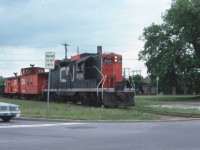 CN GP-9 4514 is returning from a trip up the Lakefield spur to retrieve a gondola car from Lakefield Research. It will soon be on the street running on Bethune Street. There are a couple of unusual things in this shot. While GP-9's were common, geeps with snow shields were not common in Peterborough. The relatively new transfer caboose showed up for a week and was not seen again. Photo from my collection, taken by my brother out the car window. 