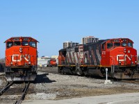 Hanging out with friends: the CN 511 job's power (left, CN 4772-4707) spends part of a warm morning at London East with CN 439's power (right, CN 4774-4791) as both crews pause for paperwork and for CN 509 to yard his train. CN GMD-1 #1444 idles on the shop track in the distance all by itself, while CN 7000 is parked across the street, behind the photographer. It seems all four GP38-2's in this photo could really use a trip through the paint booth!
