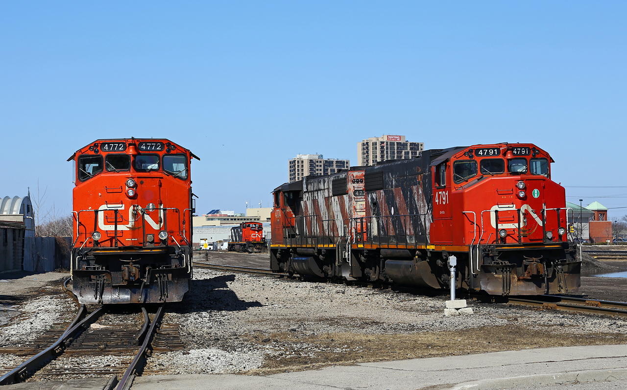 Hanging out with friends: the CN 511 job's power (left, CN 4772-4707) spends part of a warm morning at London East with CN 439's power (right, CN 4774-4791) as both crews pause for paperwork and for CN 509 to yard his train. CN GMD-1 #1444 idles on the shop track in the distance all by itself, while CN 7000 is parked across the street, behind the photographer. It seems all four GP38-2's in this photo could really use a trip through the paint booth!