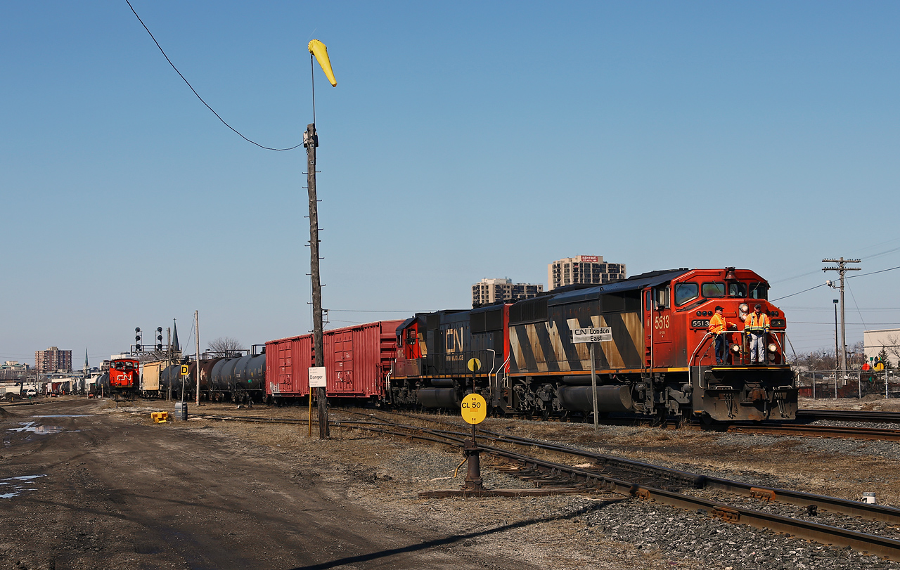 Andy brings a pretty long CN 509 into the yard at London East with the conductor and yardmaster riding on the pilot with CN 5513-IC 1012 for power. CN GMD-1 1444 rests at left on the shop track.