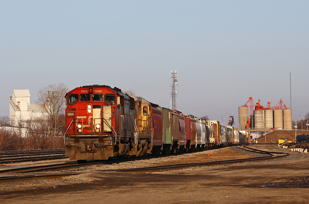 Two 1980's designed locomotives representing vastly different motive power philosophies bring a late-running CN 435 down track 6 at Racecourse yard. The classic Draper-Taper in the lead was purchased new in 1989, while the trailing unit, CN 2041, is actually a year newer having been built as CN 8541 in 1990. The train made an unscheduled stop in Woodstock after the low-hanging air hose connection between the 21st and 22nd cars snagged the crossing resulting in the train going into emergency.