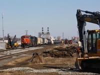 CN 5793 and IC 1009 bring an exceptionally long CN 331 through the work area at London Jct on a very warm afternoon. The old crossover switches have been replaced (old ones piled at right) along with the Guelph sub connecting switch, but the new crossovers have not yet been connected. Several excavators, a rock truck, and a front end loader are being used to conduct the trackwork along with many other smaller machines. A 20 mph TSO was in effect, no doubt frustrating motorists at the nearby grade crossings.
