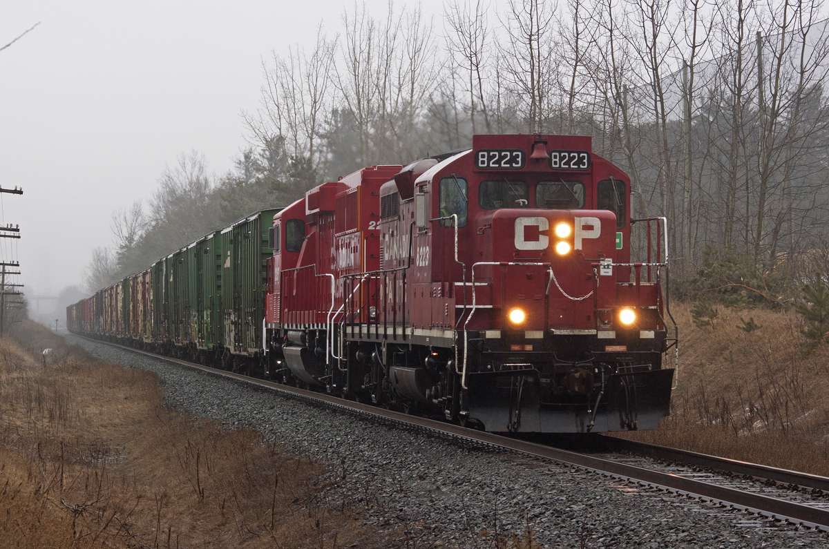 T10 (being called the management turn) pulls up the grade at Ajax with an endangered 8223 on the point. The dark, wet and gloomy day seem fitting for the GP9u, which is leading what it will soon become; an eco.