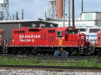 <i><b>Odd Duck</b></i>. CP GP9u 1518 sits at the diesel shop in CP's Toronto (Agincourt) Yard on a sunny day in shiny CP beaver paint. One of the early 80's GP9 rebuilds for yard service, 1518 was later equipped with two spark arrestors on her roof for switching inside the GM Oshawa automotive assembly complexes. She is also a "mother" to slug 1025 (coupled behind), another former GP9u (1534) that was converted to a slug in the early 90's after suffering an engine failure. <br><br> The ECO craze retired both, with 1518 and 1025 tied up unserviceable at Toronto Yard in December 2013, and unlikely to return to service or see a second life on a shortline.