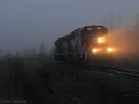 The management training train is just light power as it passed the west end of Cherrywood siding on a foggy evening. CP 2267 and 8233. 1930hrs.