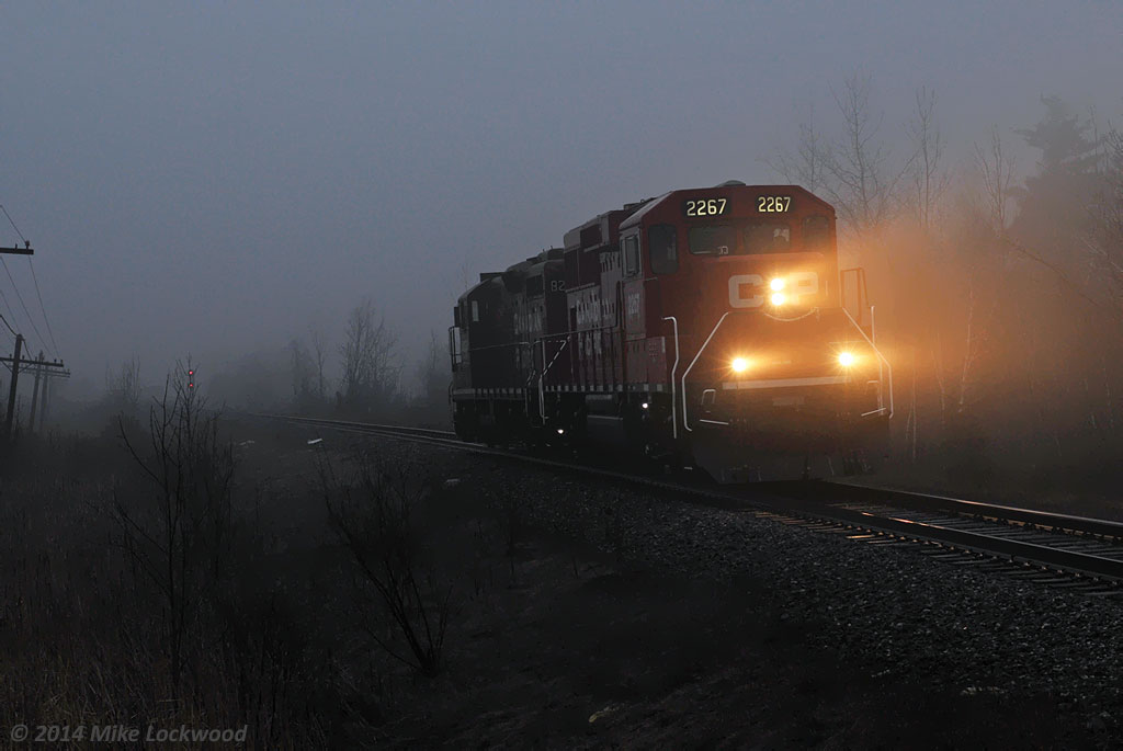 The management training train is just light power as it passed the west end of Cherrywood siding on a foggy evening. CP 2267 and 8233. 1930hrs.