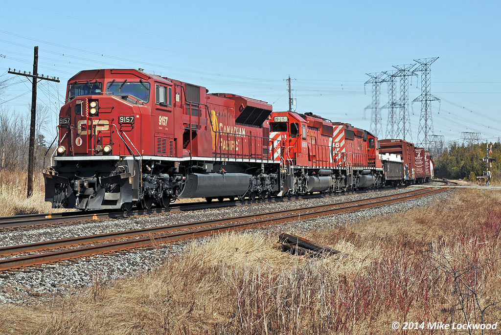 With respect to James Adney's shot of CP 9104, one of the four remaining operable SD90MAC's, CP 9157, leads 301's train past Cherrywood siding in the company of SD40-2 survivors 6069 and 5746. 1333hrs.