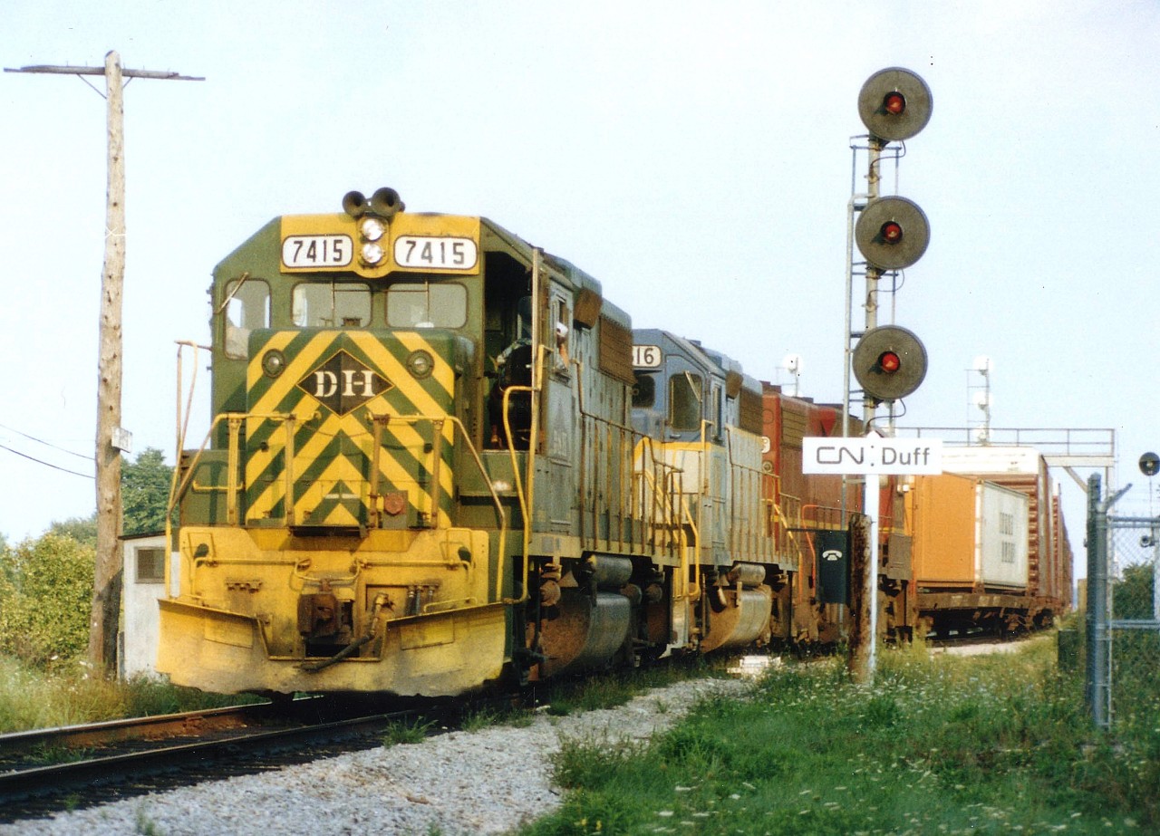 During the US Rail strike of fall 1978, some NW/DH trains were detoured over the CASO in Southern Ontario. Here we see D&H 7415, 7616 and 7315 just coming off the yard trackage onto the mainline at CN Duff westbound. Interesting power on the D&H back then. After the restructuring of the Northeastern US Railways upon the creation of Conrail; the D&H ended up with Reading (first unit), and Lehigh Valley (third unit). The middle unit is the famed "lightning stripe" scheme that made this line so popular with the fans.