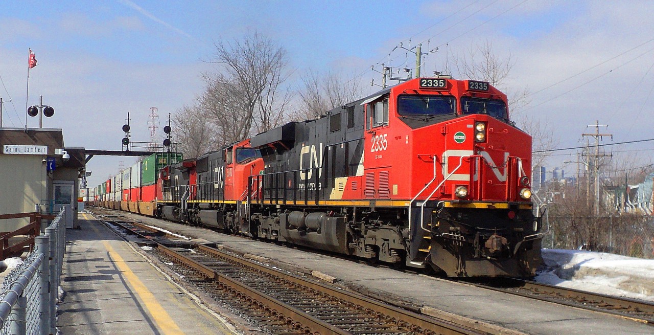 CN-2335 a EF-644-M leading loco with CN-5600 a SD-75I as second locos and  CN-2179 C-40-8W the 3 locos are pulling a convoy of containers of 12,000 feets according of the CN controller on CN route 120 to Halifaqx Nova Scotia