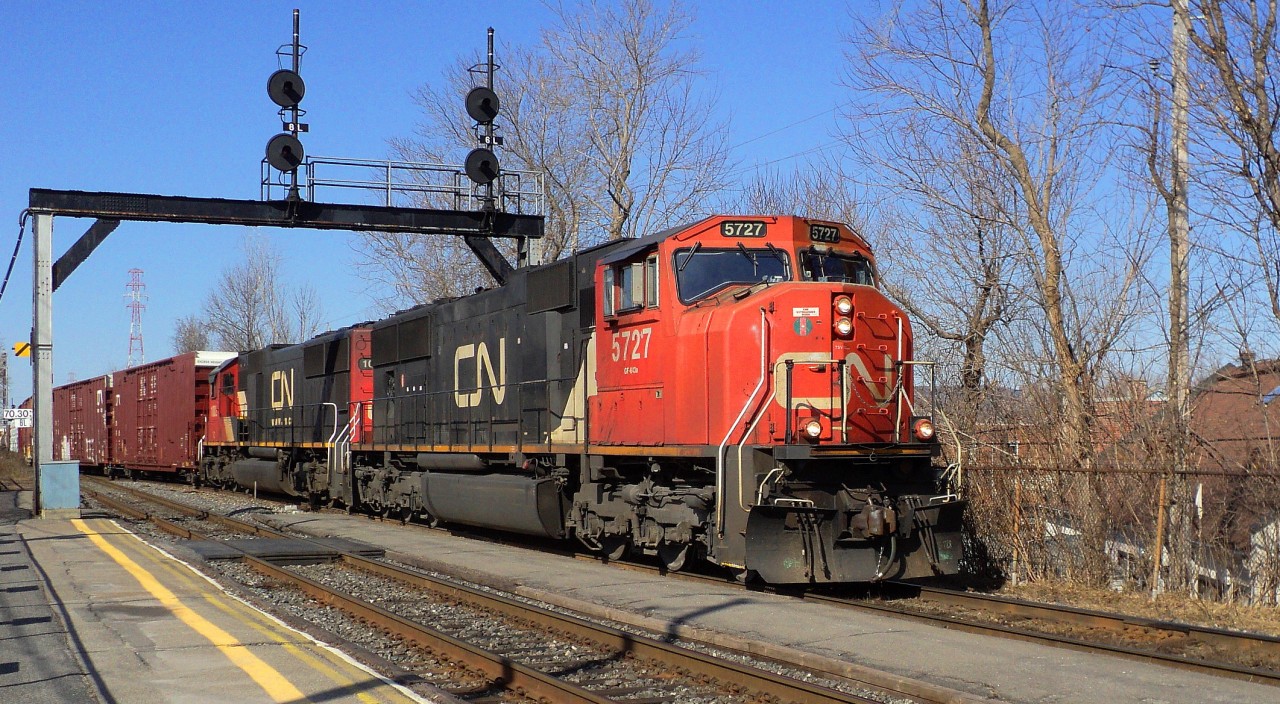 CN-5727 a SD-751-s leading loco of a convoy of mix cars crossing from South main track to north main track clearing South track for Via rte 15 coming from Halifax N.S.late plus pull CN-5667