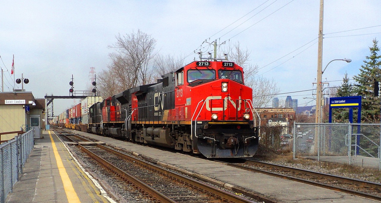 CN-2713 a EF-644-b leading loco follow of CN-8906 a SD-70-M2 plus Illinois Central 1032 a SD-70 all 3 pulling a long convoy of containers that you could see up in Victoria bridge over 11,000 feets coming from Toronto going to Halifax plus a bacgrounnd of Downtown Montréal buildings